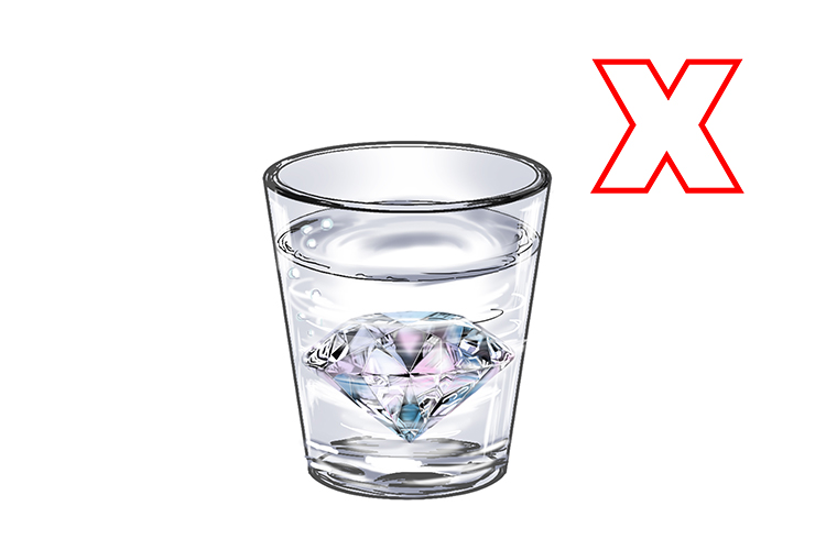 glass of water with a diamond in it